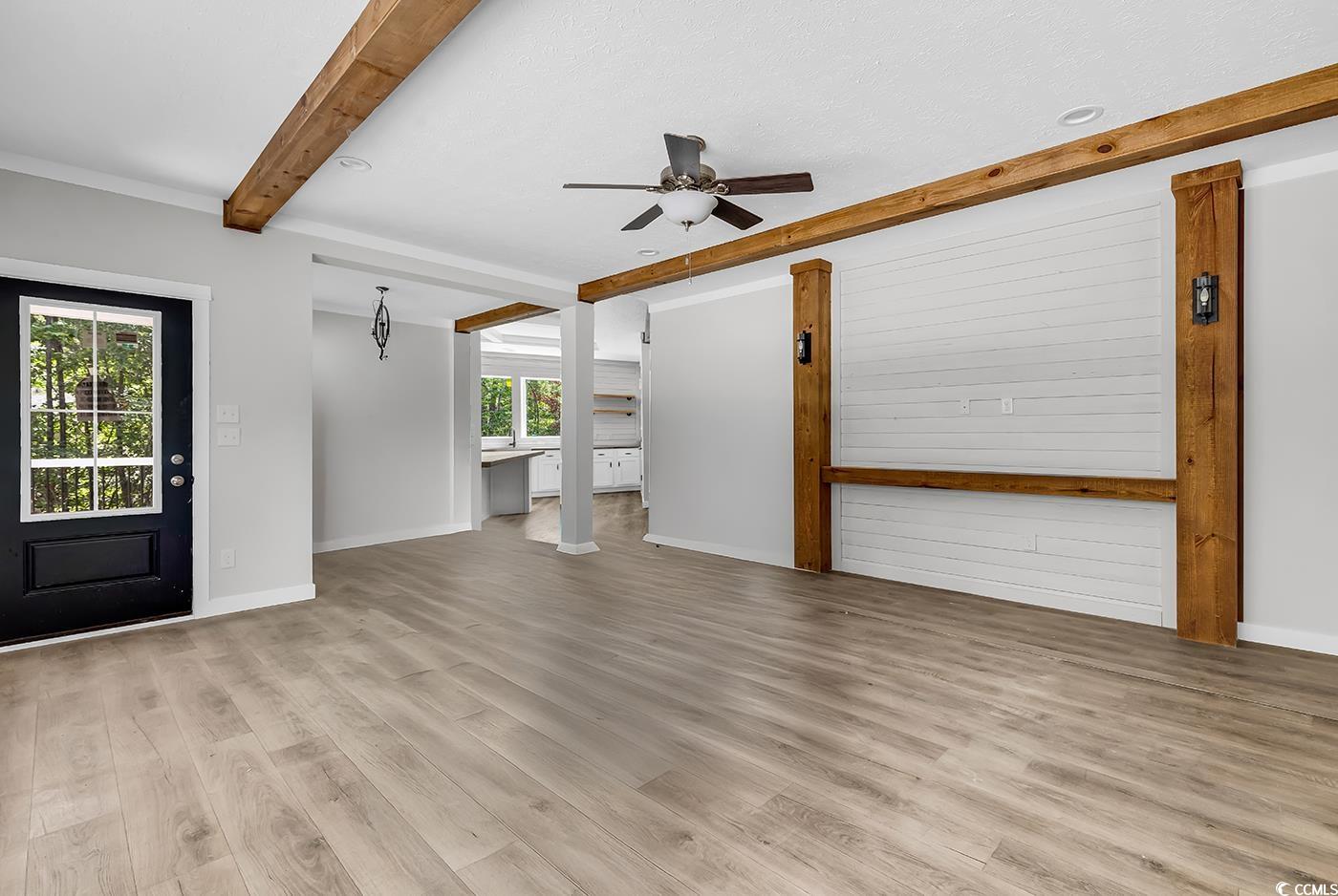 754 Kent Road Andrews, SC 29510 - Photo 5 of 31 Unfurnished living room featuring beamed ceiling, light wood finished floors, and ceiling fan