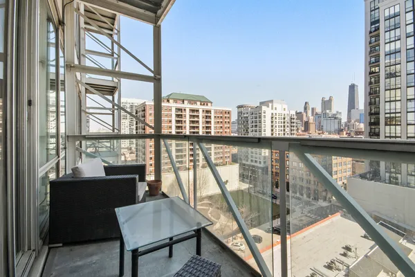 a view of a balcony with furniture and wooden floor