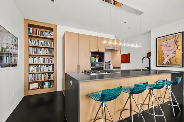 a kitchen with stainless steel appliances granite countertop a sink a stove and a refrigerator