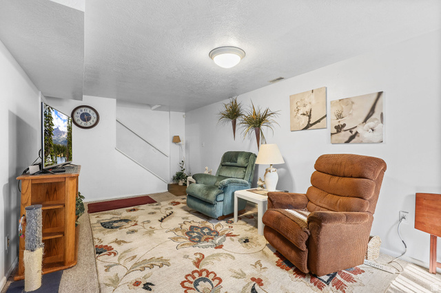 1120 Canyon Road, Unit 38 Ogden, UT 84404 - Photo 22 of 24 Sitting room with a textured ceiling and baseboards