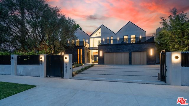 a bedroom with a large bed and a large window