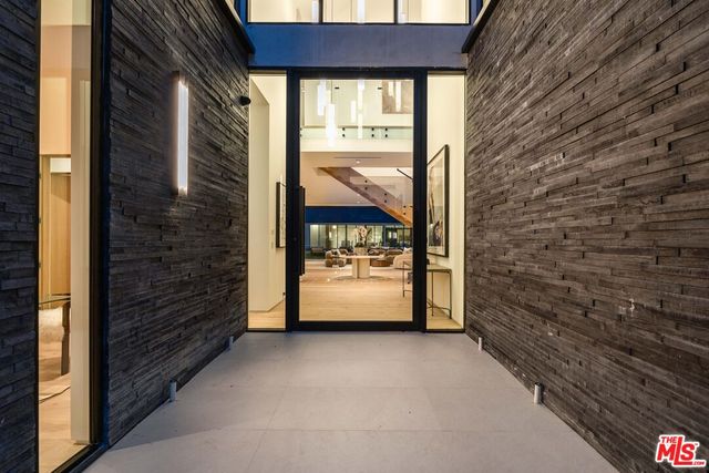 a spacious bedroom with a bed couch and a large window