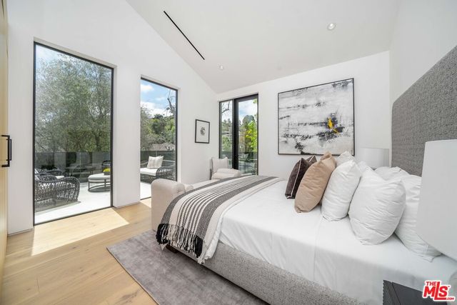 a view of a house with a yard and potted plants