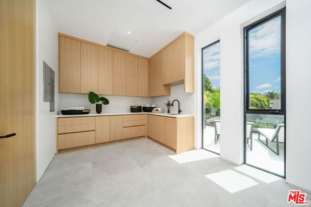 a view of an house with swimming pool and chairs