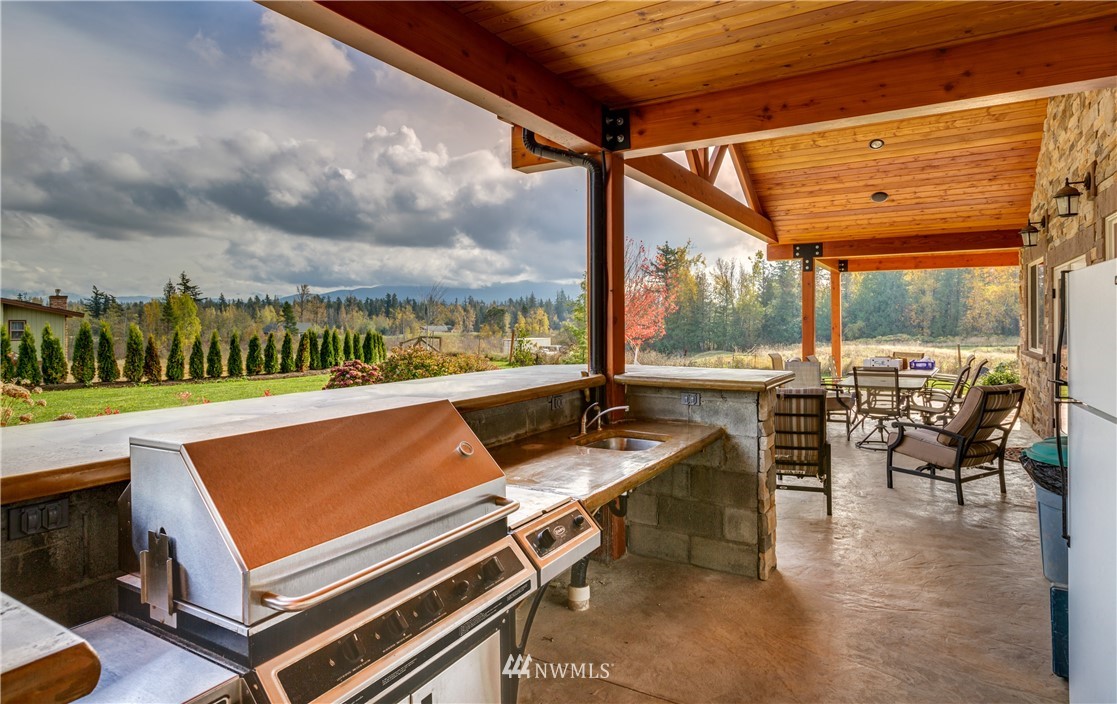 6460 Everson Goshen Road Everson, WA 98247 - Photo 21 of 37 a view of a patio with chairs and a table