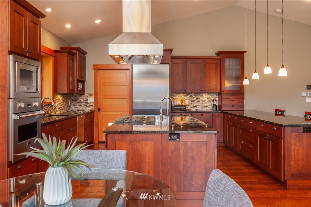 6460 Everson Goshen Road Everson, WA 98247 - Photo 10 of 37 a kitchen with stainless steel appliances granite countertop a table chairs and a refrigerator