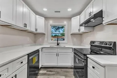 a kitchen with stainless steel appliances granite countertop a sink a stove and a microwave