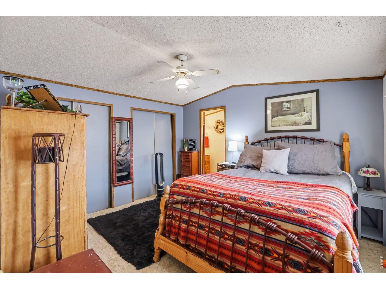 1401 9th Street, Unit 159 Fort Lupton, CO 80621 - Photo 2 of 24 Primary bedroom with double closets and an ensuite bathroom.