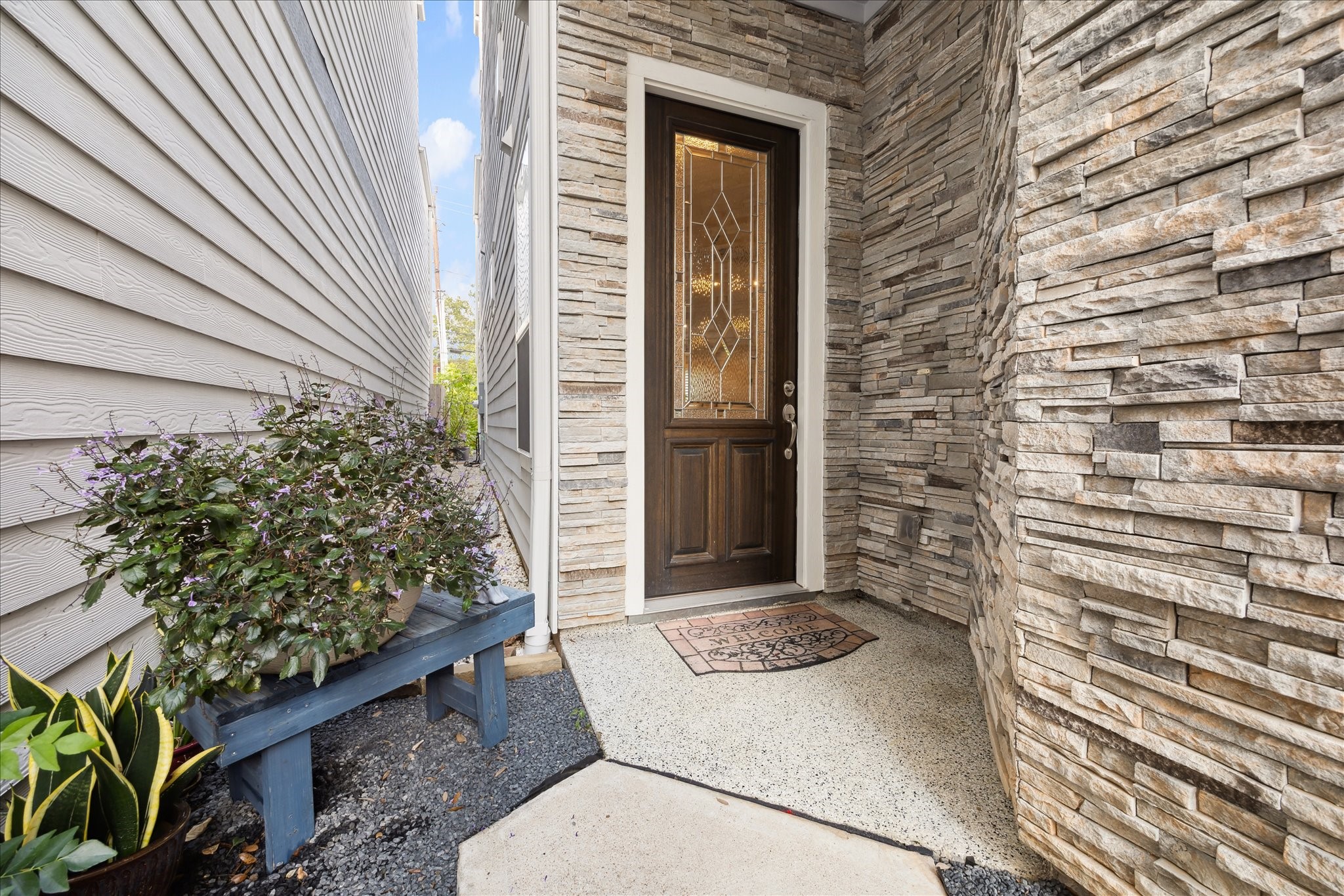 [Entrance] Welcoming stone-accented entryway that sets the tone for the home’s modern elegance, blending warmth and sophistication..