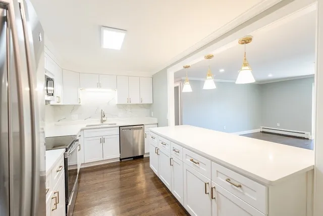 a kitchen with white cabinets and white appliances