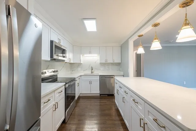 a kitchen with a white cabinets and sink