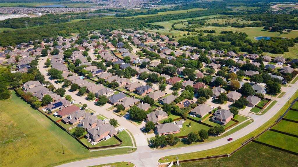an aerial view of a residential houses with outdoor space and street view