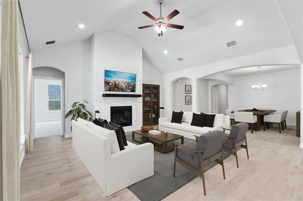 715 Soprano Drive Forney, TX 75126 - Photo 8 of 16 a living room with furniture a fireplace and a flat screen tv