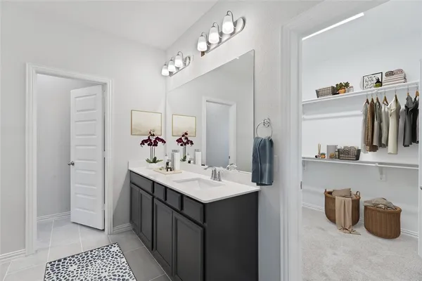 a bathroom with a double vanity sink a toilet and a mirror