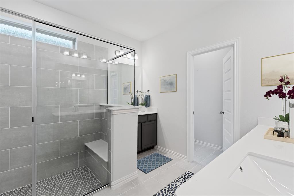 715 Soprano Drive Forney, TX 75126 - Photo 11 of 16 a bathroom with a shower sink and mirror