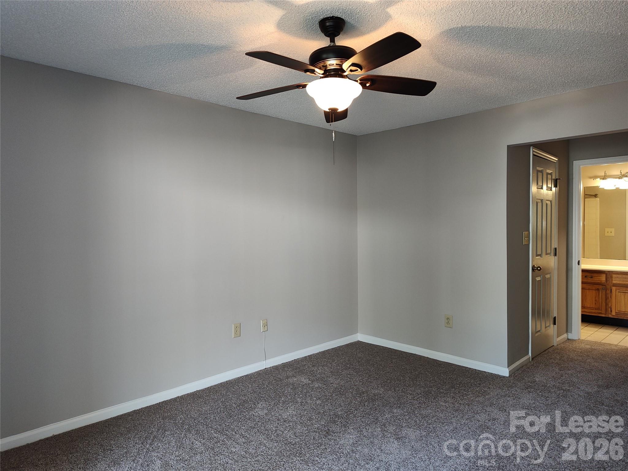 5001 Sharon Road, Unit K Charlotte, NC 28210 - Photo 17 of 24 an empty room with a chandelier fan