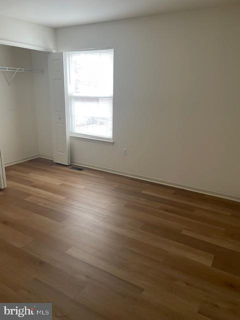 9200 Old Newtown Road Philadelphia, PA 19115 - Photo 12 of 36 an empty room with wooden floor and windows