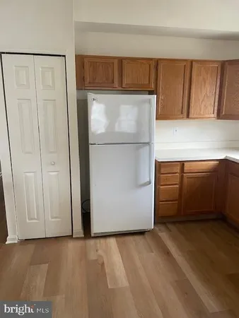a view of storage and utility room with fridge