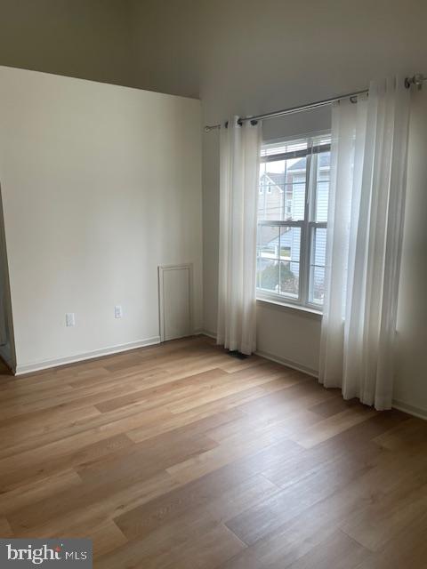 9200 Old Newtown Road Philadelphia, PA 19115 - Photo 19 of 36 an empty room with wooden floor and windows with curtains