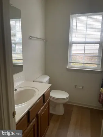 a bathroom with a sink toilet and window