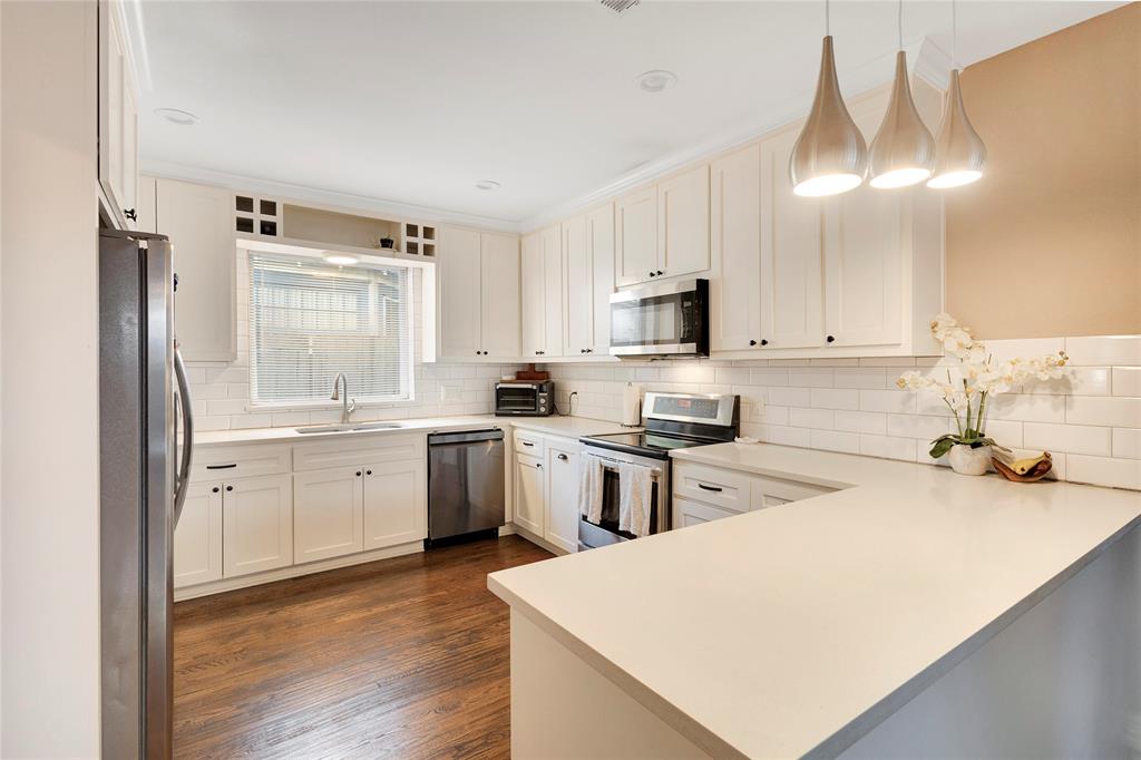 828 Elsbeth Street Dallas, TX 75208 - Photo 12 of 35 a kitchen with appliances a sink and cabinets