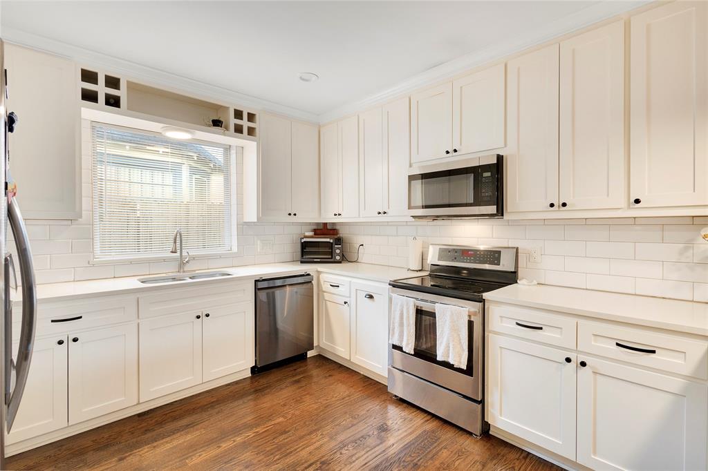 828 Elsbeth Street Dallas, TX 75208 - Photo 13 of 35 a kitchen with white cabinets and white appliances