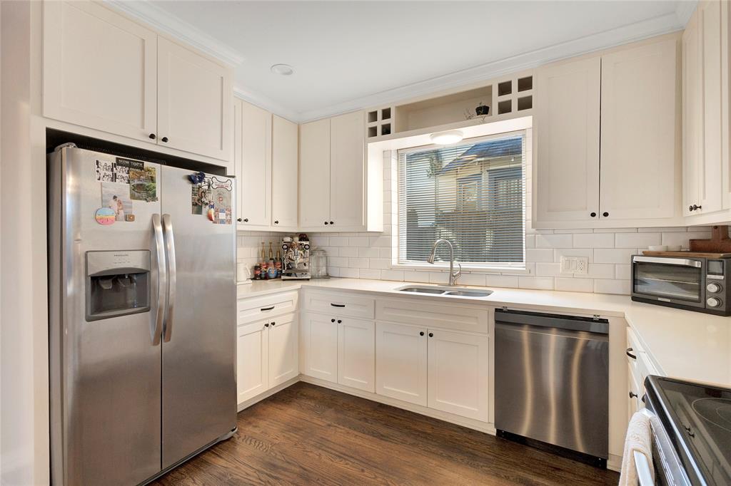 828 Elsbeth Street Dallas, TX 75208 - Photo 14 of 35 a kitchen with stainless steel appliances granite countertop a refrigerator a sink and white cabinets
