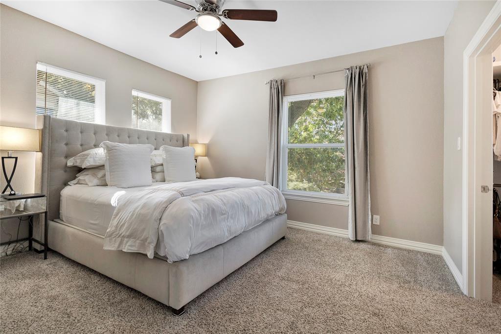 828 Elsbeth Street Dallas, TX 75208 - Photo 19 of 35 a bed sitting in a spacious bedroom next to a window
