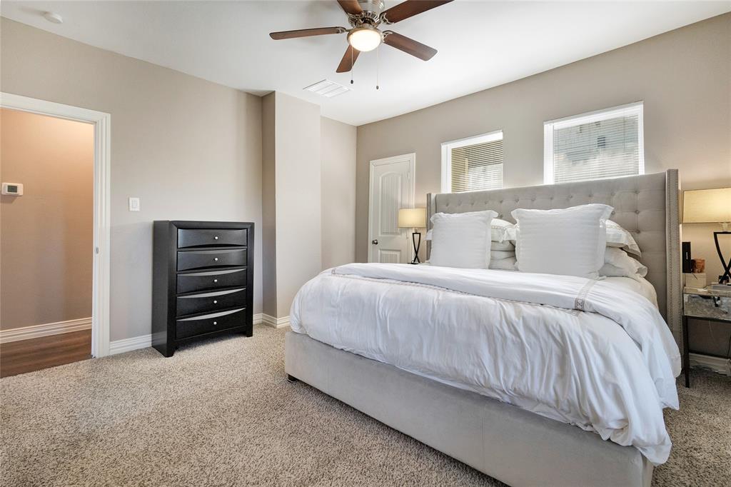 828 Elsbeth Street Dallas, TX 75208 - Photo 20 of 35 a bedroom with a bed and a chandelier