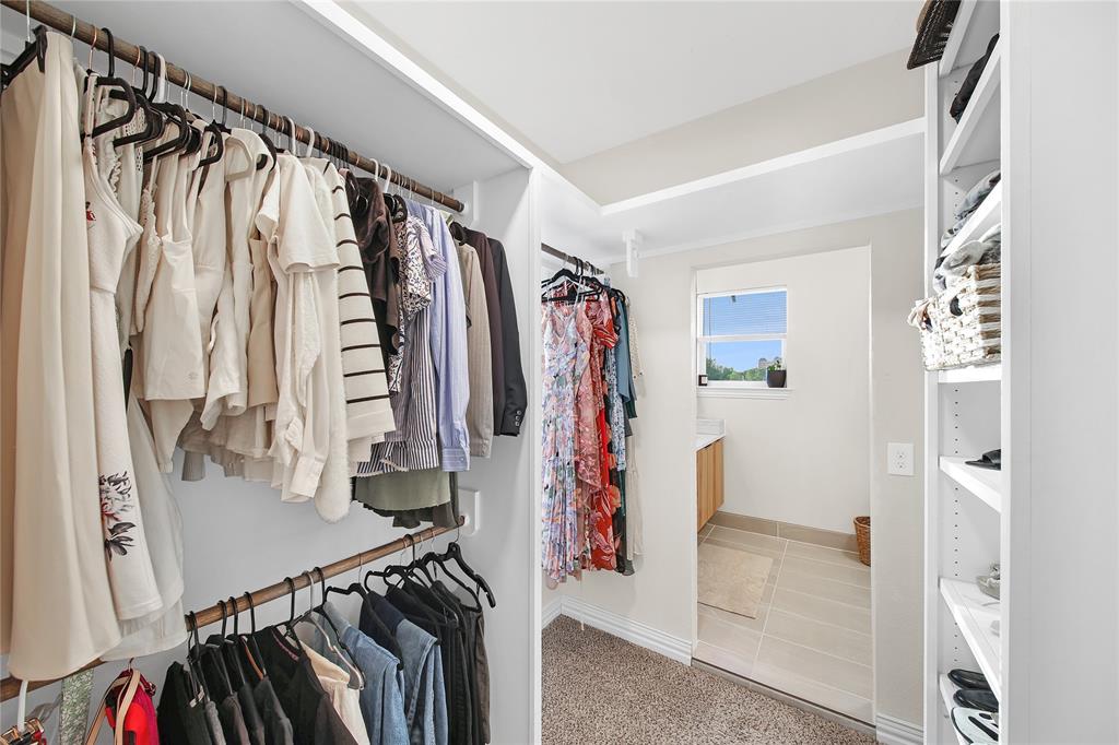 828 Elsbeth Street Dallas, TX 75208 - Photo 21 of 35 a view of walk in closet with clothes and shoes
