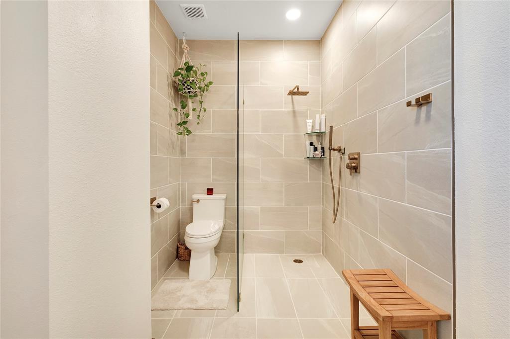 828 Elsbeth Street Dallas, TX 75208 - Photo 22 of 35 a bathroom with a shower a toilet and a sink
