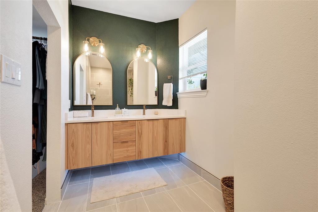 828 Elsbeth Street Dallas, TX 75208 - Photo 23 of 35 a bathroom with a double vanity sink and a mirror