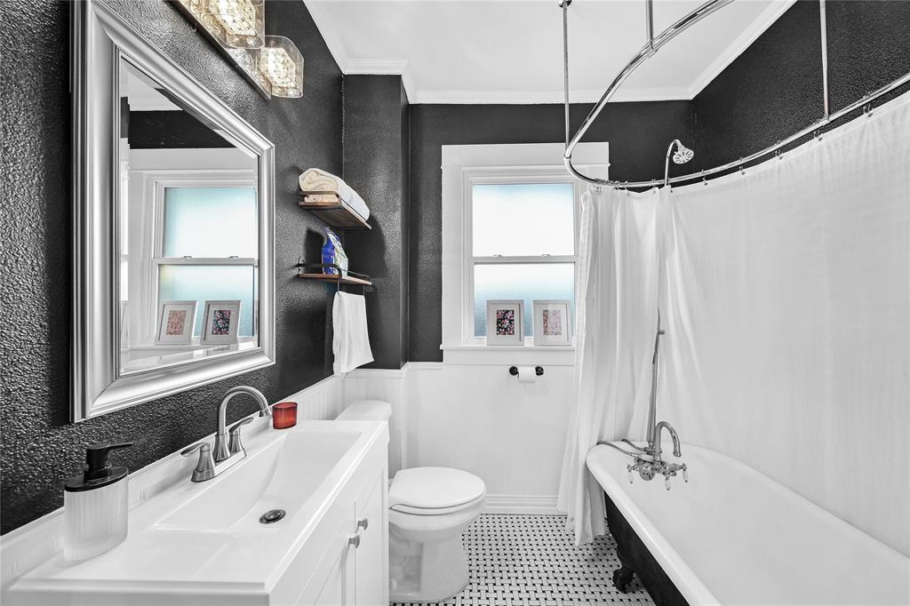 828 Elsbeth Street Dallas, TX 75208 - Photo 26 of 35 a bathroom with a sink a toilet and a mirror