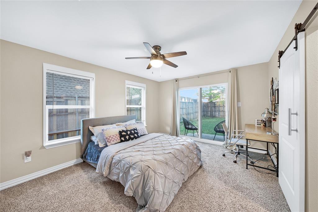 828 Elsbeth Street Dallas, TX 75208 - Photo 28 of 35 a bedroom with a bed and a large window with outer view