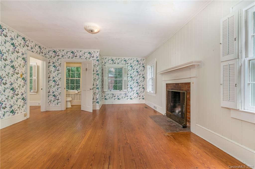 402 Chimney Rock Road Rutherfordton, NC 28139 - Photo 13 of 36 wooden floor fireplace and windows in an empty room