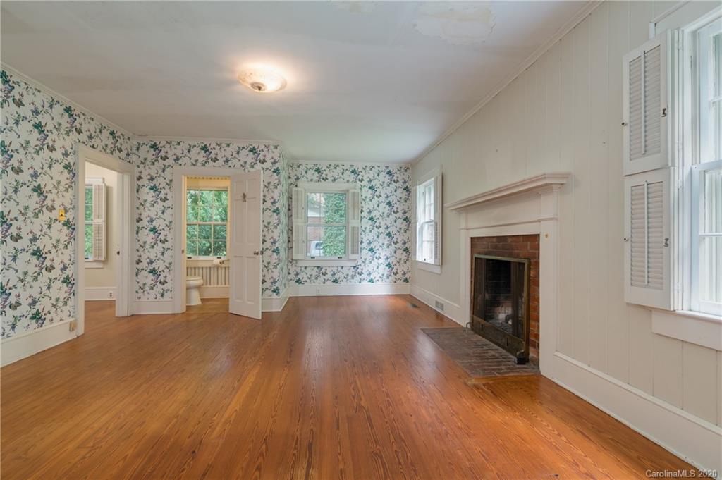 402 Chimney Rock Road Rutherfordton, NC 28139 - Photo 14 of 36 wooden floor fireplace and windows in an empty room