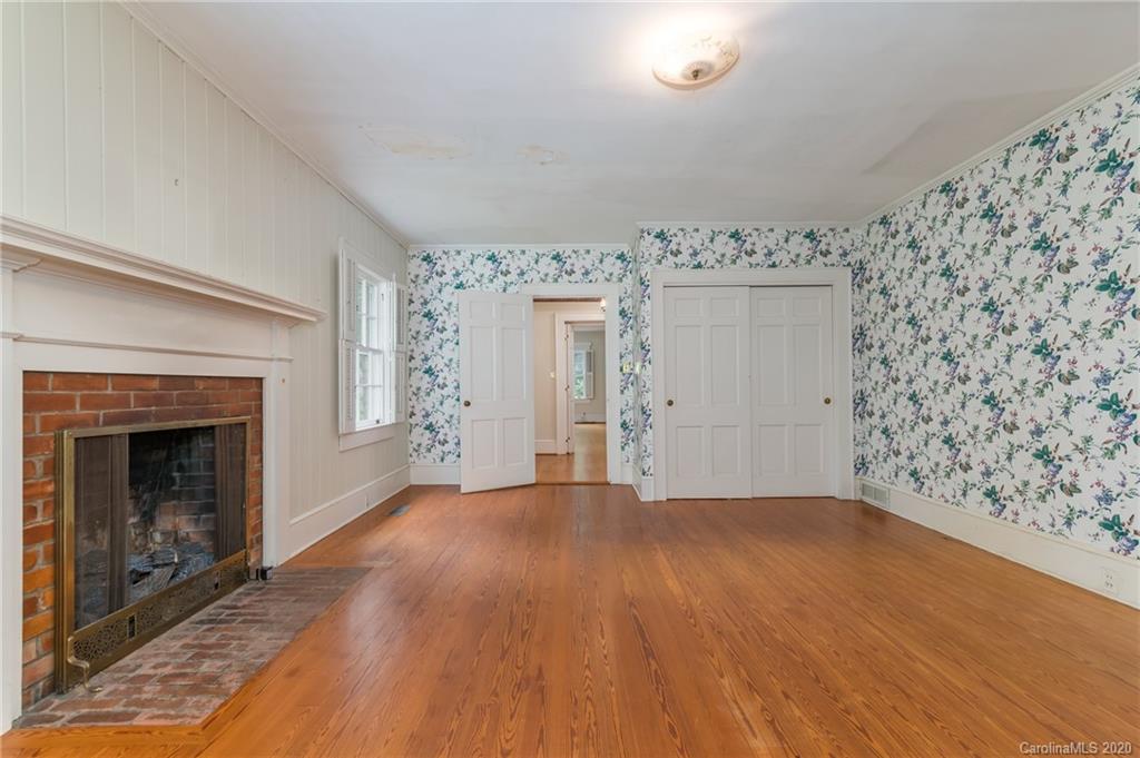 402 Chimney Rock Road Rutherfordton, NC 28139 - Photo 16 of 36 a view of empty room with wooden floor and fireplace