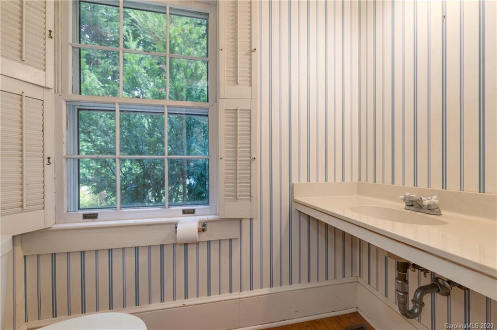 402 Chimney Rock Road Rutherfordton, NC 28139 - Photo 17 of 36 a bathroom with a sink and a window