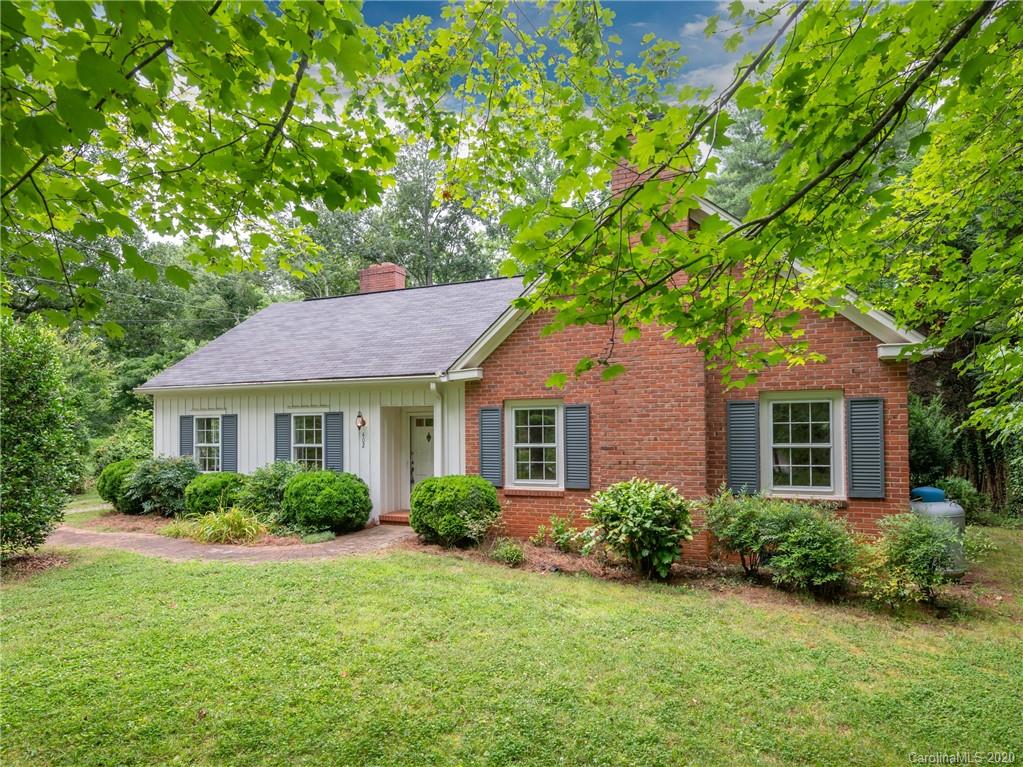 402 Chimney Rock Road Rutherfordton, NC 28139 - Photo 24 of 36 a house that is sitting in front of a big yard with potted plants and large trees