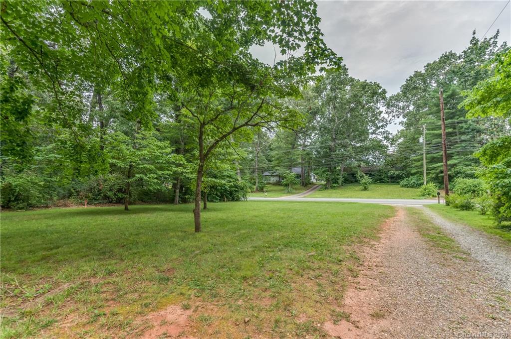 402 Chimney Rock Road Rutherfordton, NC 28139 - Photo 33 of 36 a view of a grassy field with trees in the background
