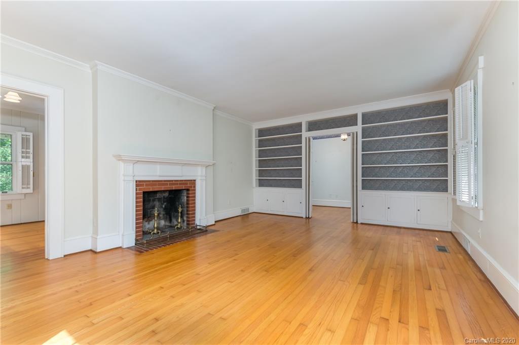402 Chimney Rock Road Rutherfordton, NC 28139 - Photo 5 of 36 a view of empty room with wooden floor and fireplace