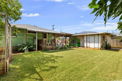 a view of a house with backyard and porch