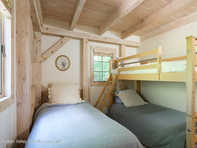 a bedroom with bed and a chair