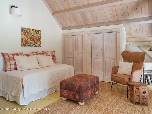 a bathroom with a granite countertop sink a large mirror and a bathtub