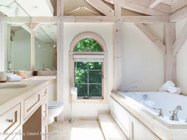 a bedroom with a large bed and a flat screen tv