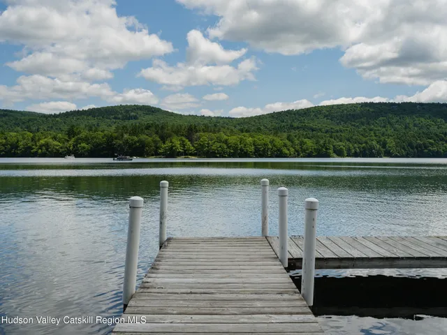 a view of a backyard with chairs and a grill
