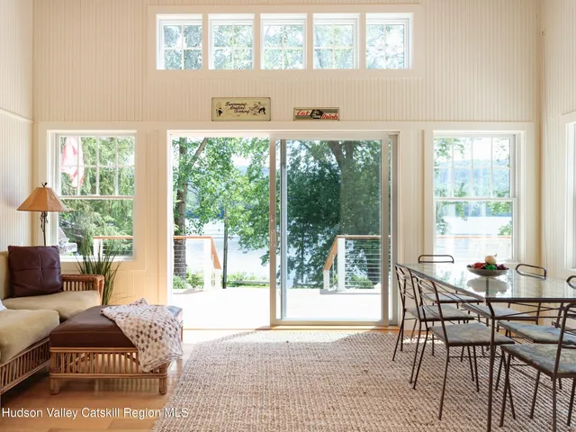 a living room with furniture and a floor to ceiling window