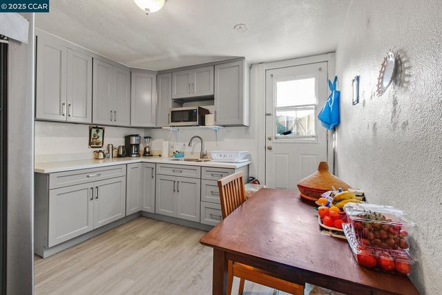 a kitchen with cabinets appliances a sink and a counter top