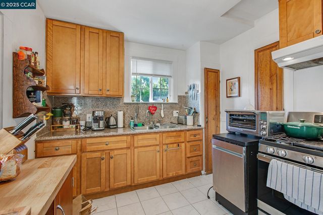 a kitchen with stainless steel appliances a refrigerator and a stove