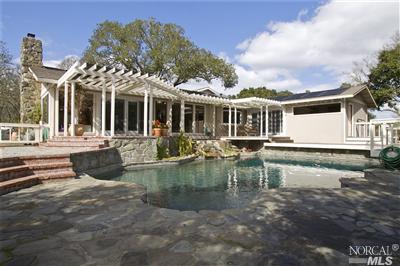 a view of a house with swimming pool and porch